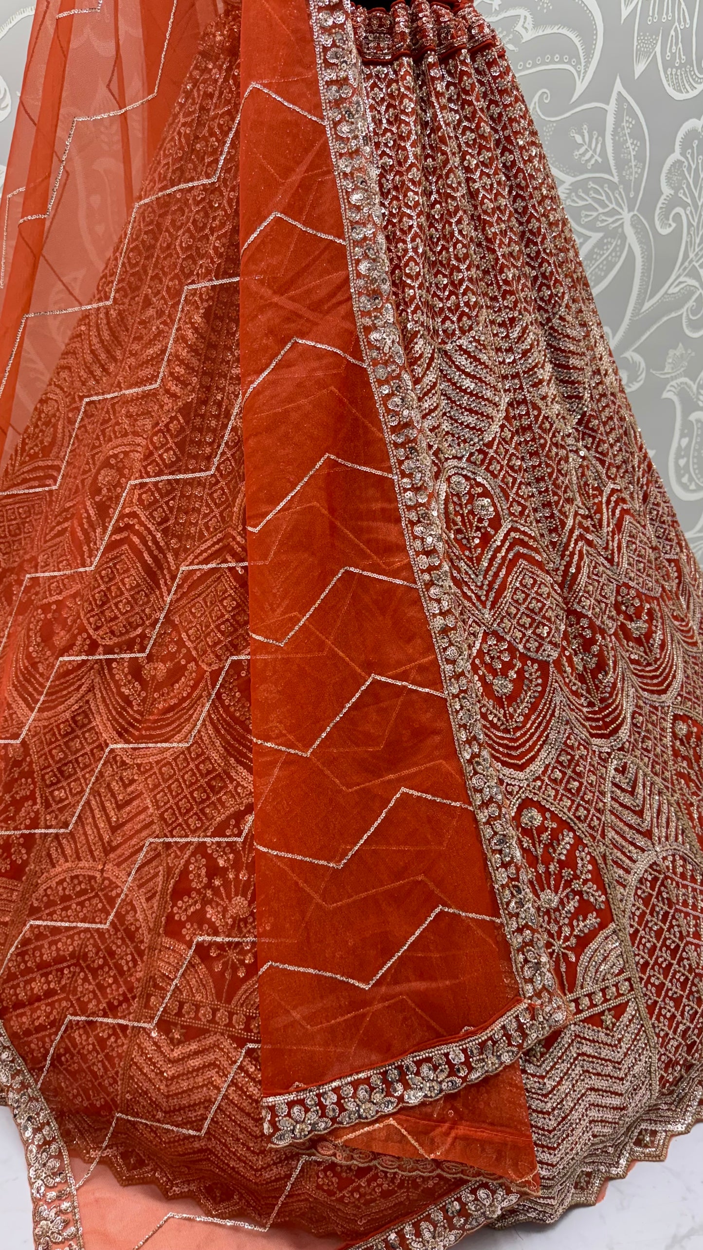 Rust Orange Net Party Wear Lehenga Choli with Crystal Motif & Sequins Work